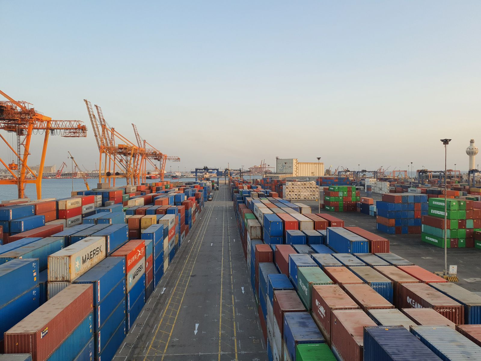 Cargo containers at a busy port at sunrise