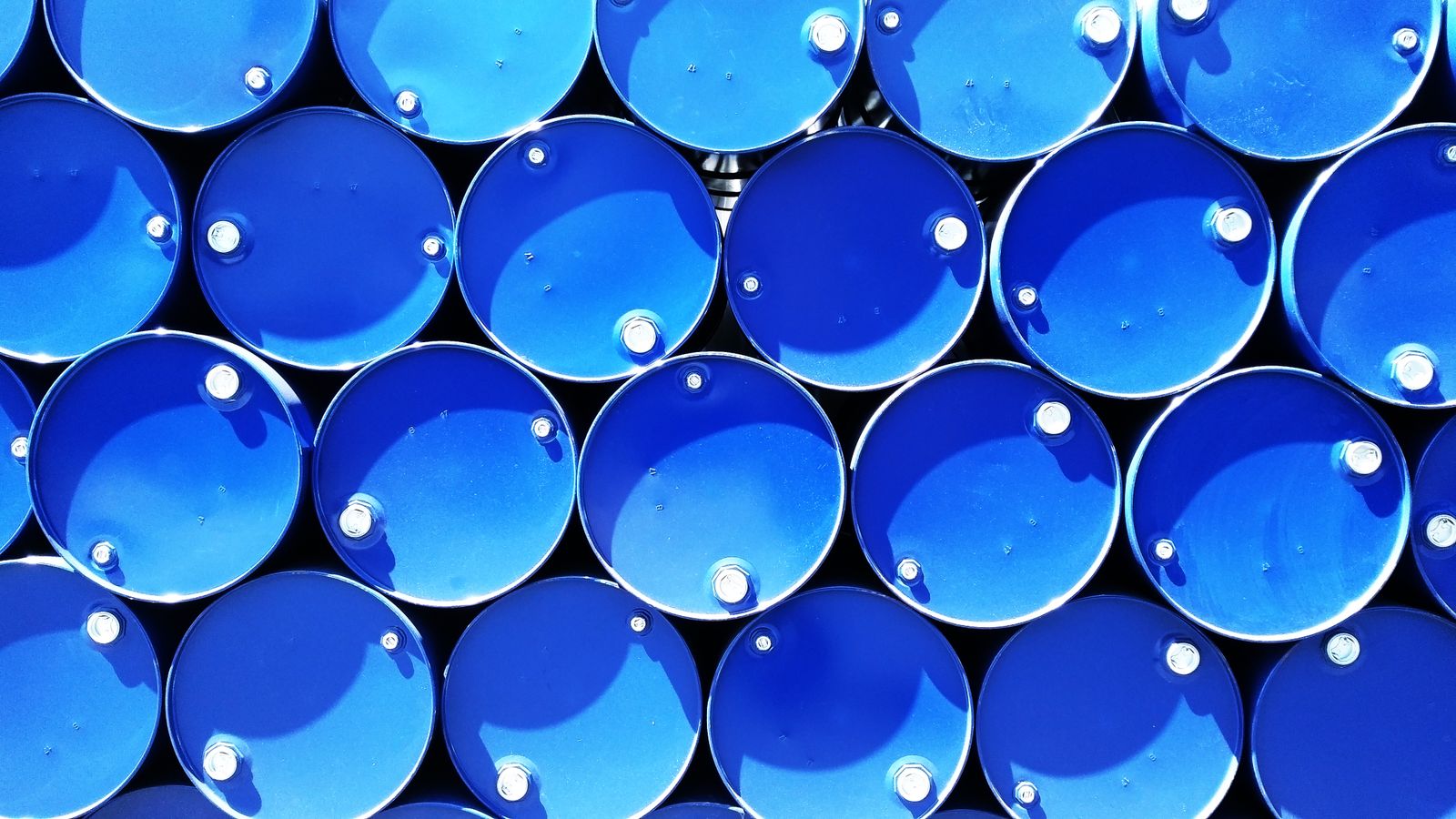 Stacked blue industrial chemical drums